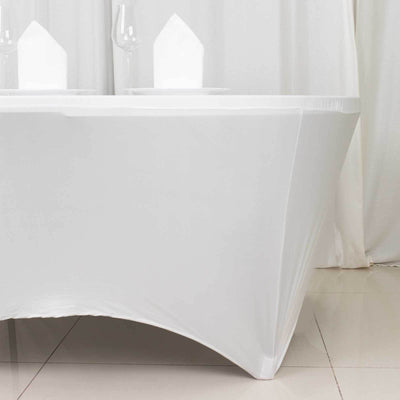 White table with elegant draping and glassware set for dining.