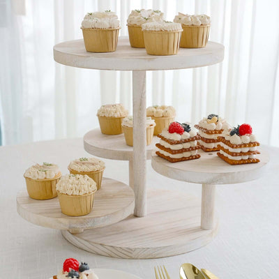 Wooden cupcake stand with assorted cupcakes and desserts arranged on three tiers.