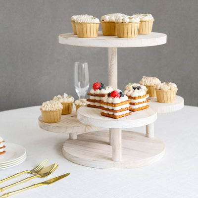 Tiered dessert stand with cupcakes and cookies on a table.