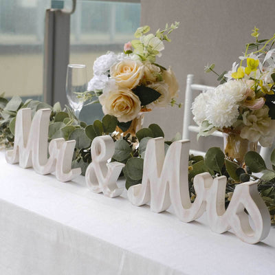 "Mr & Mrs wedding table decor with flowers and greenery"