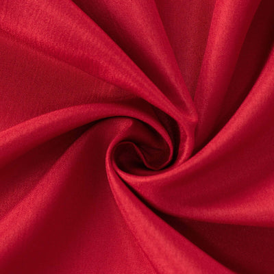 Red fabric texture in a swirling pattern.