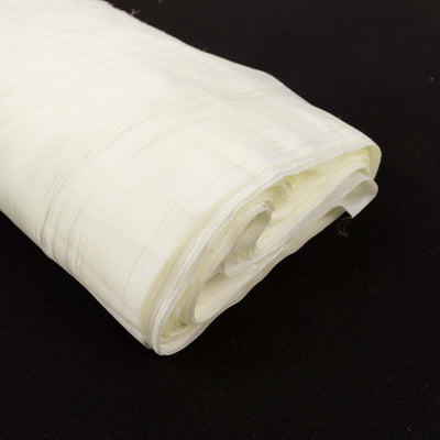 Rolled white fabric on a black background.