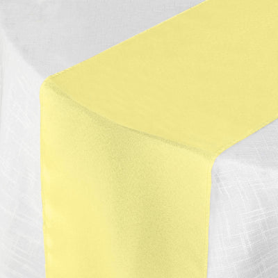 Yellow table runner on a white tablecloth
