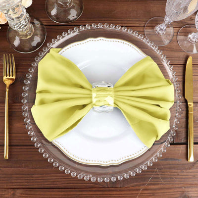 Elegant green napkin bow on a decorative plate setting.