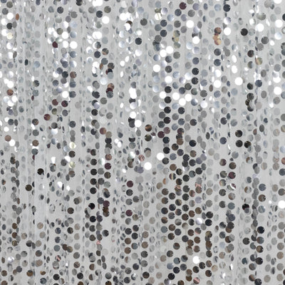 Abstract silver sequin curtain with shimmering metallic discs close-up