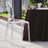 Clear acrylic chair beside a table in an outdoor setting.