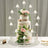 Elegant three-tier wedding cake adorned with flowers and candles.