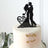 Bride and groom cake topper in black silhouette design.