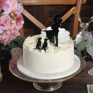 Decorative cake with elegant floral accents and silhouette of a woman with dogs.
