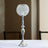 Elegant crystal table lamp with a silver stand and decorative globe shade.