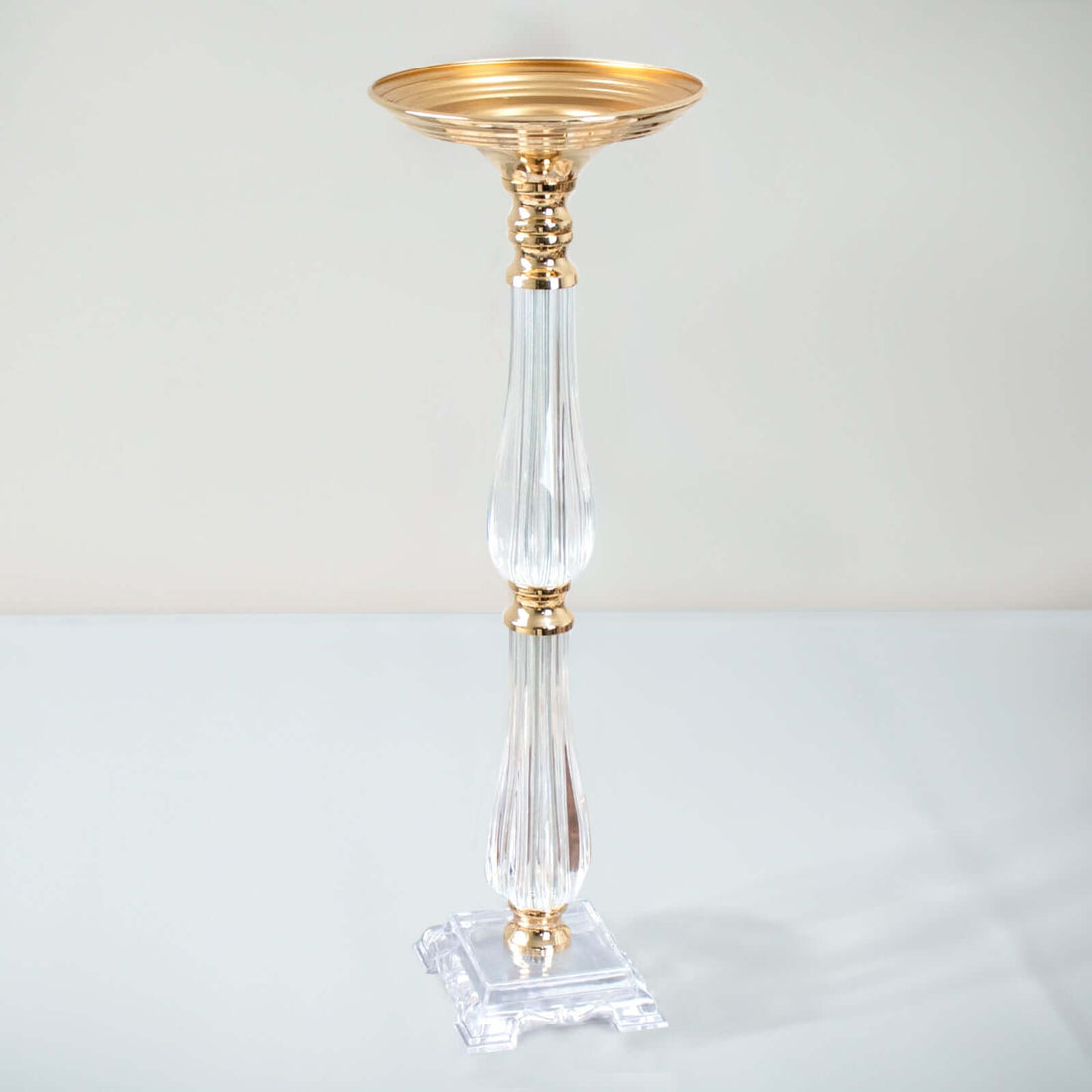 Elegant gold and crystal candle holder on a plain background
