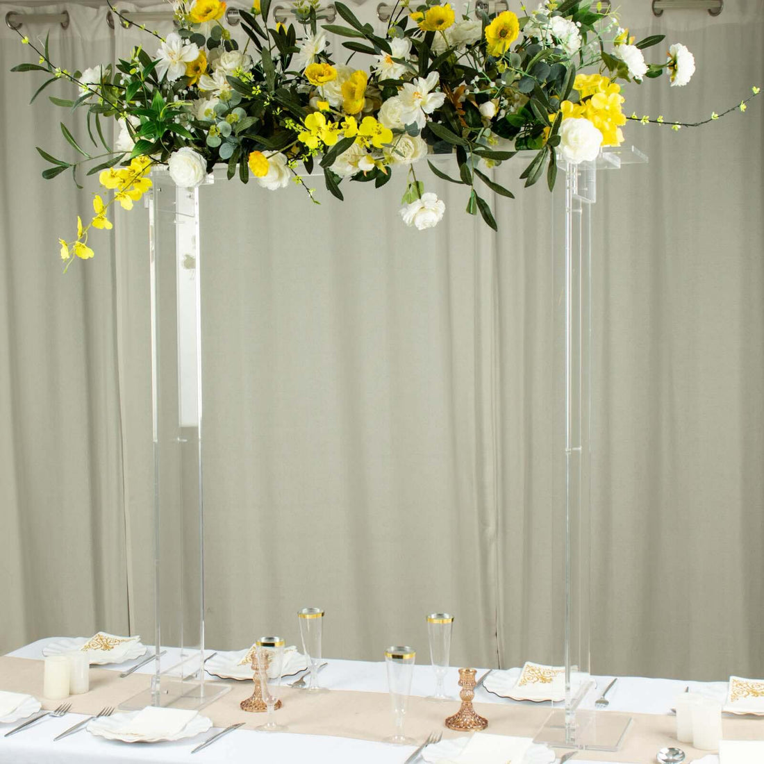 Elegant floral arch centerpiece with yellow and white flowers for event decor.