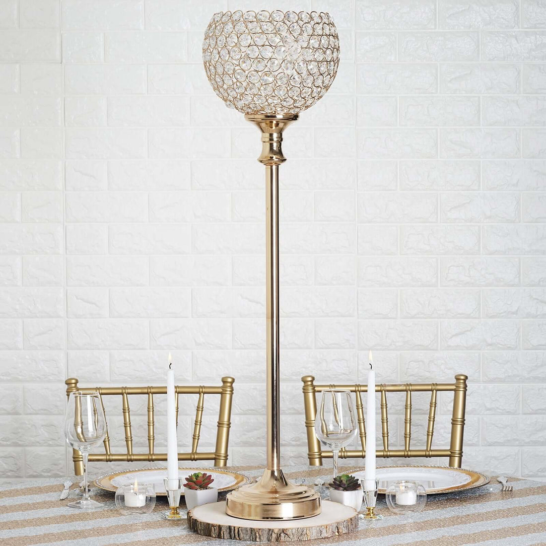 Elegant gold table lamp with crystal globe on a dining table setting.