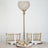 Elegant gold table lamp with crystal globe on a dining table setting.
