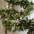 Artificial eucalyptus garland with warm LED lights on a decorative ladder.