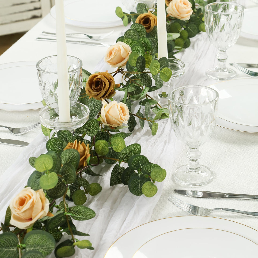 Elegant table setting with floral centerpiece and glassware.