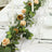 Elegant table setting with floral centerpiece and glassware.