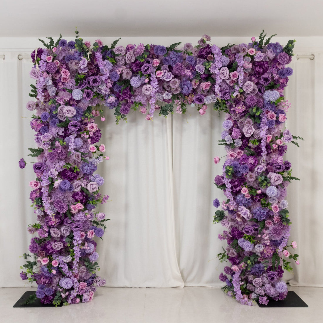 Purple floral archway decoration for events and weddings.