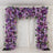 Purple floral archway decoration for events and weddings.
