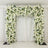 White floral archway with greenery against a plain backdrop.