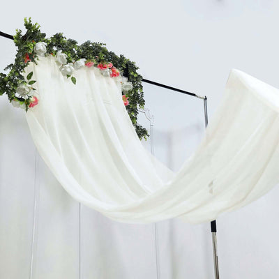 White draped fabric with floral accents on a display stand