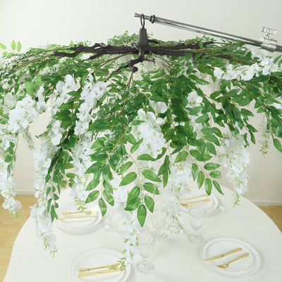 Artificial floral chandelier with white orchids and green leaves.
