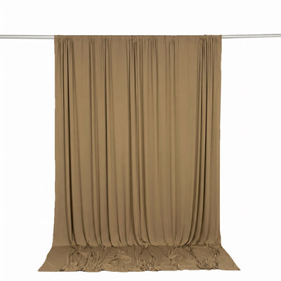 Beige draped curtain panel on a rod against a white background
