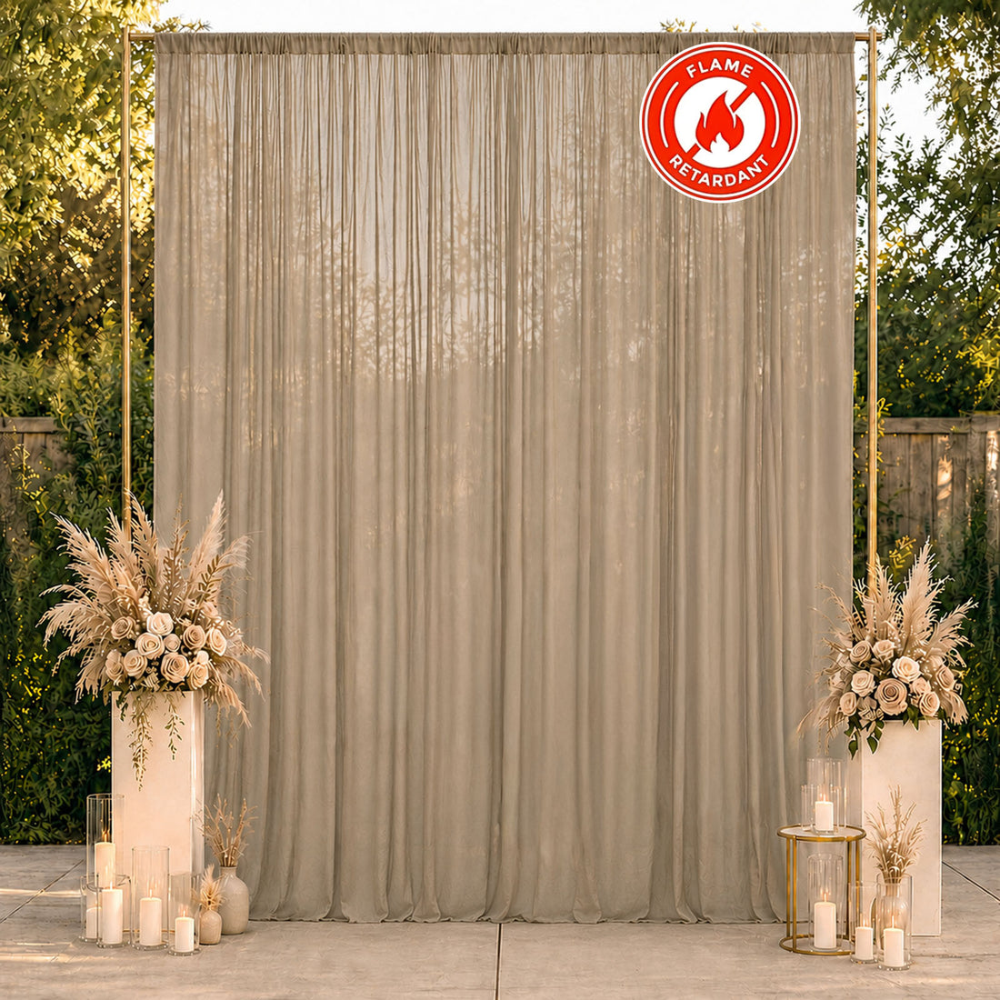 Beige flame retardant event backdrop with floral pedestals and candles
