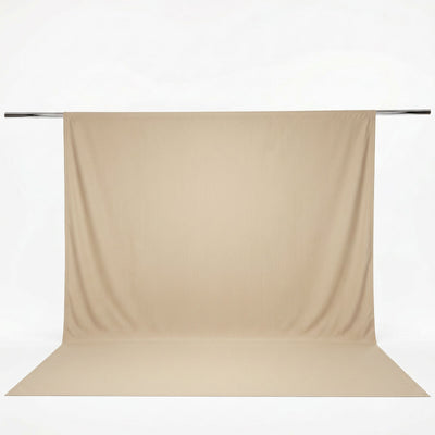 Beige photography backdrop with seamless floor sweep on metal support bar#whtbkgd
