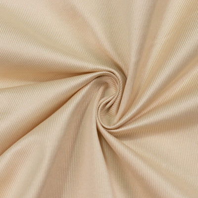 Beige ribbed fabric swirl texture close-up
