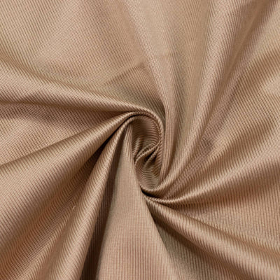 Beige ribbed fabric texture with swirled folds, close-up background#whtbkgd