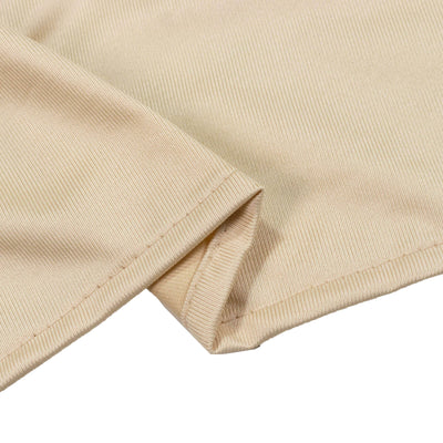 Beige ribbed knit fabric close-up with folded hem detail
