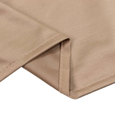 Beige ribbed knit fabric close-up with folded hem detail