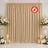 Beige wedding backdrop curtain with floral arrangements and candles, flame retardant