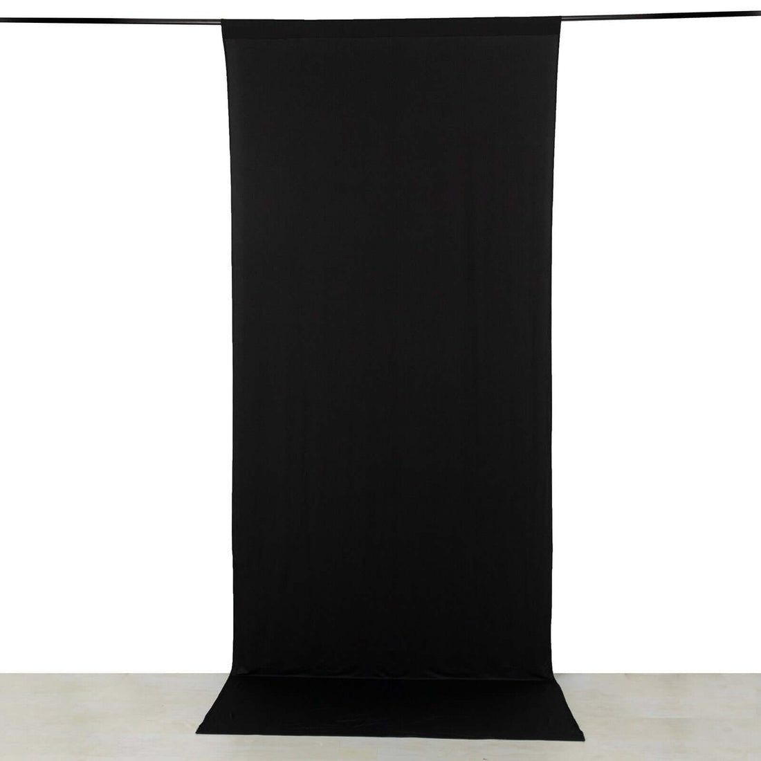 Black backdrop fabric for photography or videography setup.