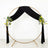 Gold circular wedding arch with black drapery and floral accents