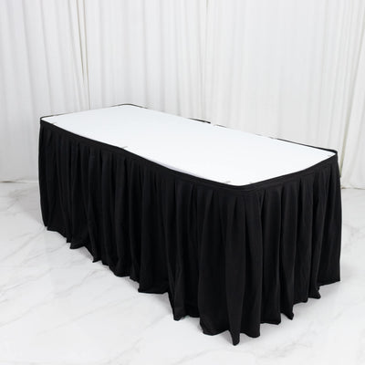 Black banquet table skirt with white tabletop in a studio setting