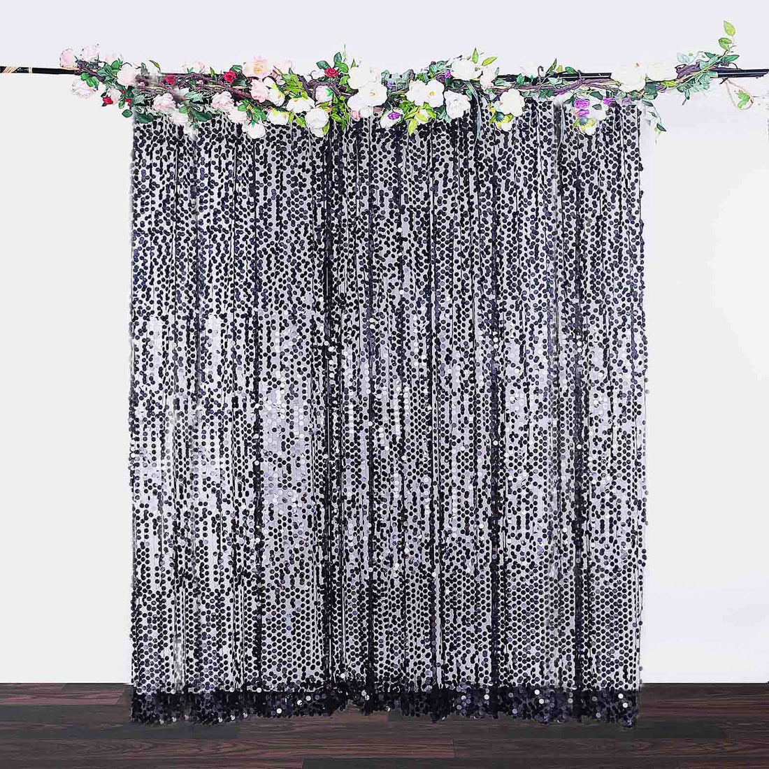 Sequin curtain draped elegantly on a rod with floral accents