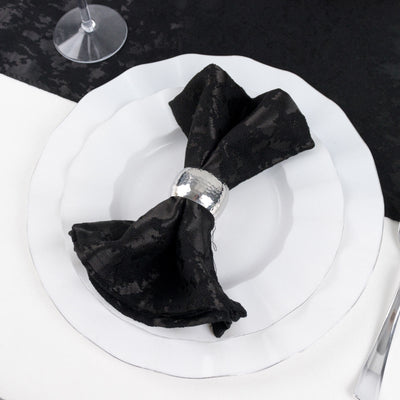 Black bow napkin ring on white plate at elegant table setting