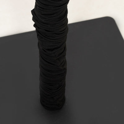 Black textured fabric wrapped around a pole.