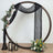 Decorative floral arch with drapes and lanterns for events or photography.