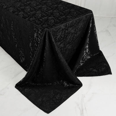 Black jacquard tablecloth draped over rectangular table, elegant home decor