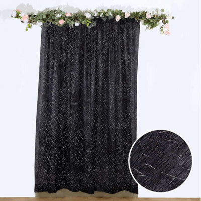 Black sheer curtain with silver speckles against a white background.