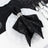 Black napkin folded on white dinner plate with silver cutlery, elegant table setting