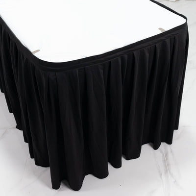 Black pleated table skirt with white tabletop for event and banquet decor