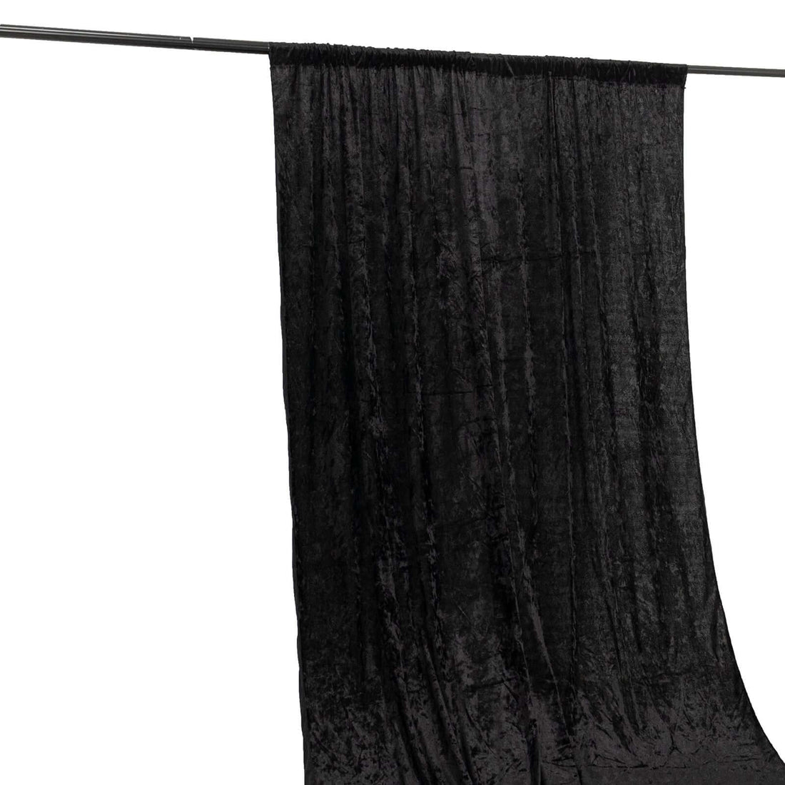 Black velvet backdrop hanging from a rod for photography.