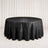 Black round satin tablecloth on banquet table with elegant draped backdrop