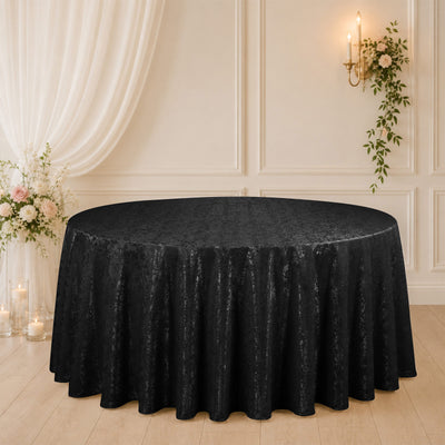 Black round tablecloth on elegant floral wedding reception table setup