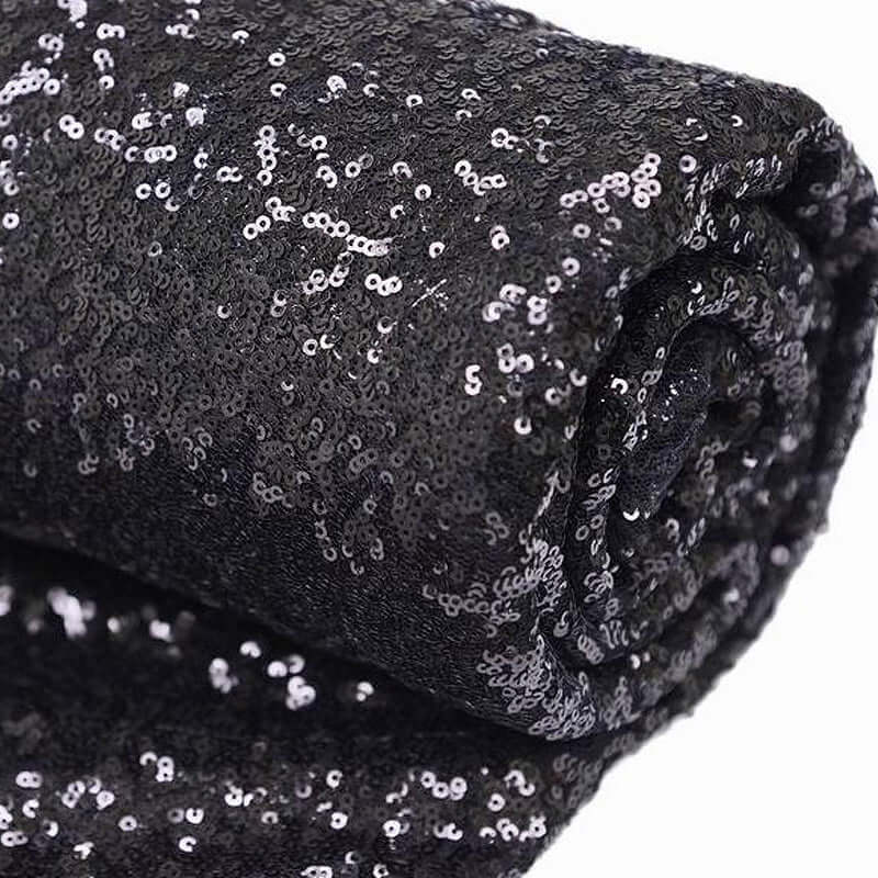 Black sequin fabric roll for crafting and decoration. #whtbkgd