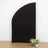 Black curved backdrop with artificial flowers on the floor.
